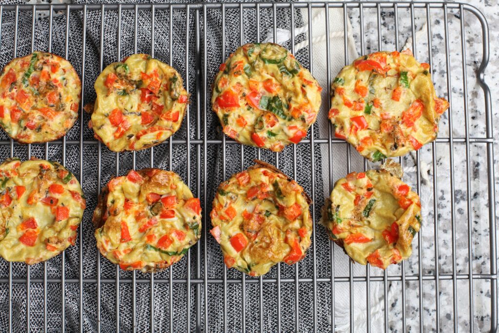 Spinach feta egg muffins in a muffin tin or container